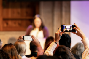 Audience taking photos of a presenter at EPIC2022