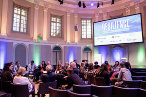 People in discussion groups in the main hall at EPIC2022