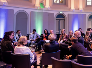 Conference attendees talking in a discussion group.